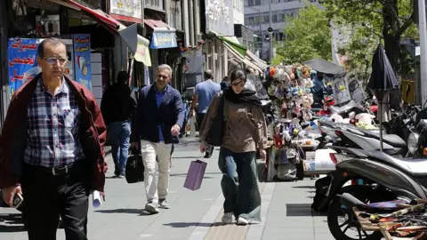 Tehran's Daily Struggle: Economic Hardships Amid Threat of War