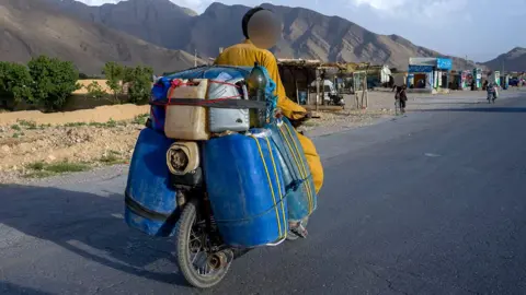 Motorbike smugglers cut through heat and conflict to ferry Iranian fuel to Pakistan